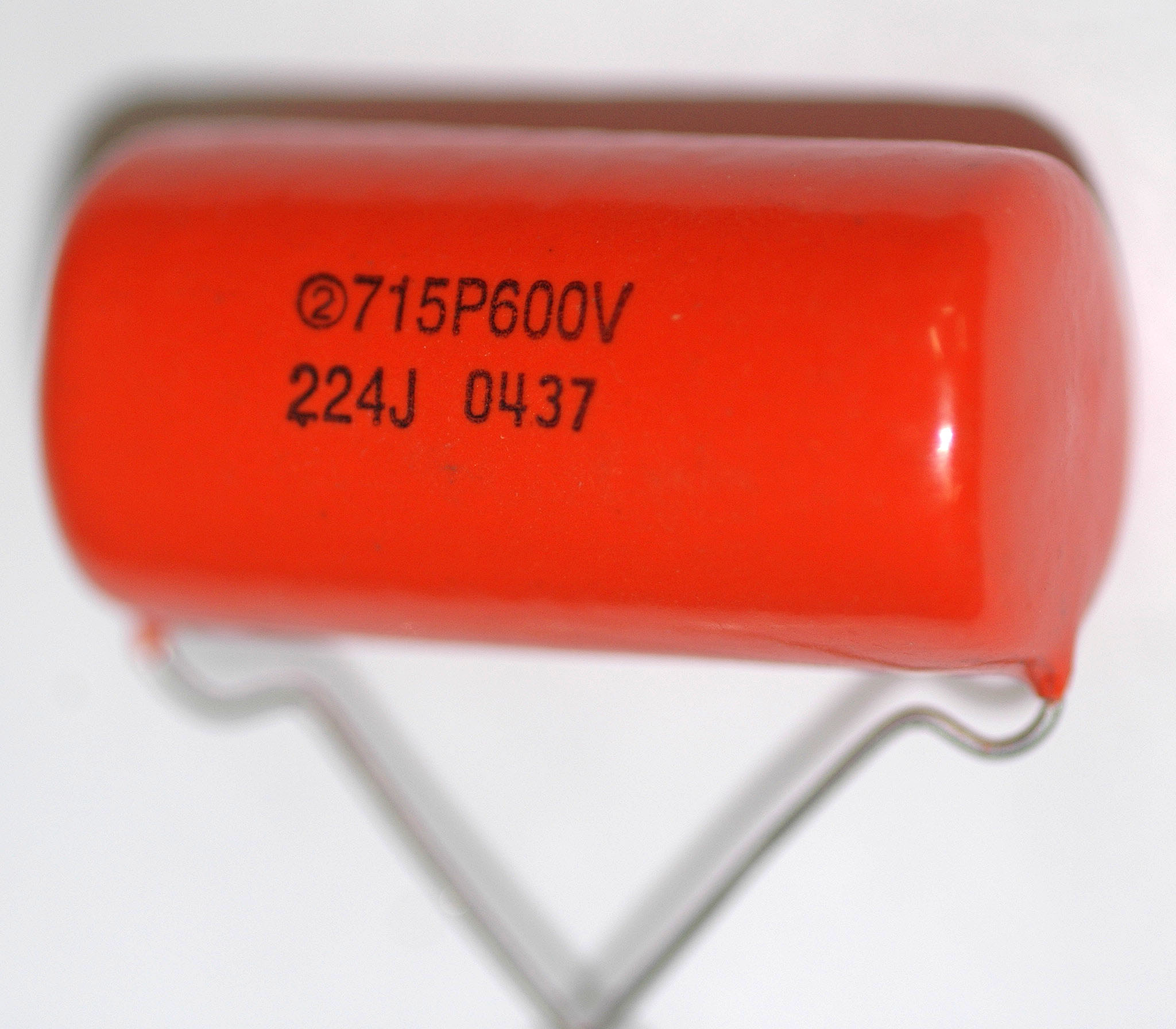 Figure 8 — The popular replacement: a Sprague 715P "orange drop," a polypropylene film-and-foil capacitor. Modern film caps like this drop straight into a vintage coupling or bypass position, match…