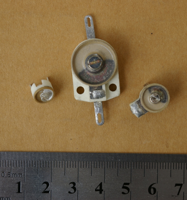 Figure 8 — Ceramic trimmer capacitors: small screwdriver-set adjustable capacitors used to align a circuit once and leave it. Rotating the top electrode over the ceramic dielectric sweeps a few pic…