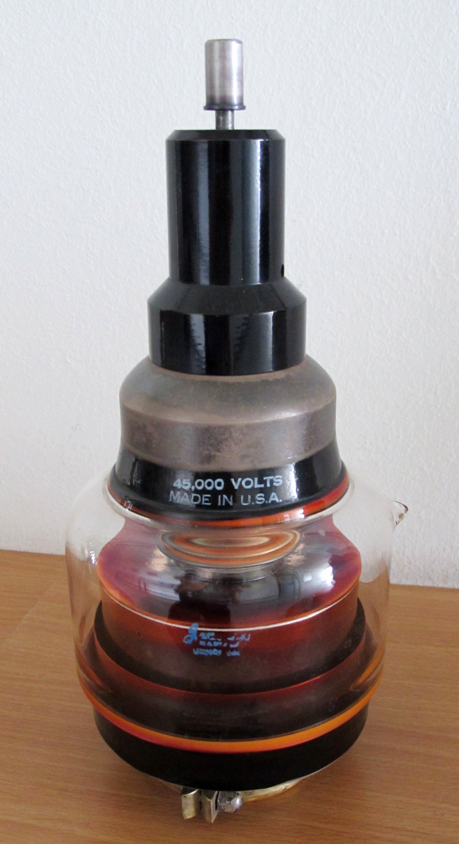 Figure 5 — A vacuum variable capacitor (rated 10–200 pF at 40 kV). The value is changed by a bellows that lets a screw drive the nested electrodes in and out of mesh without ever breaking the vacuu…