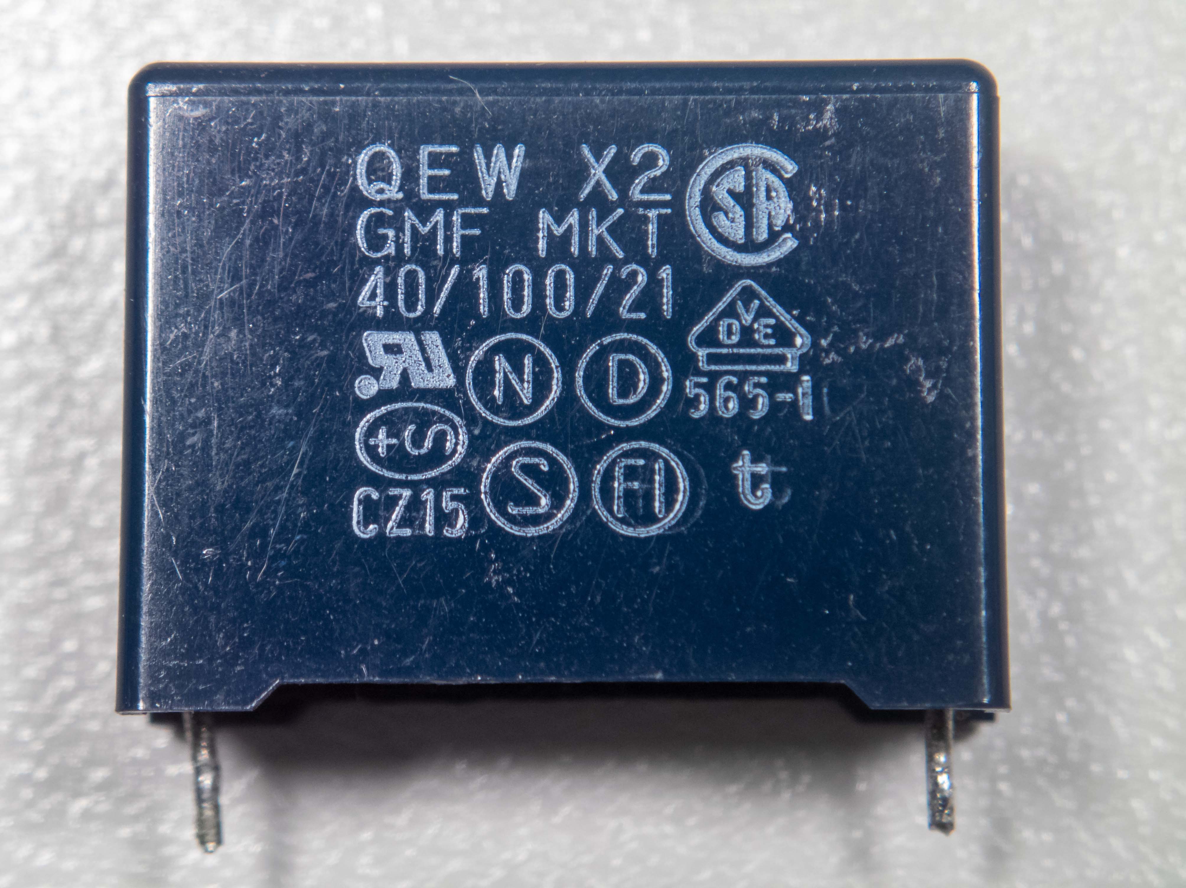 Figure 7 — An X2-class metallized-polypropylene interference-suppression capacitor, connected line-to-neutral across the mains and marked with its safety approvals and 275/305 VAC rating. Source: p…
