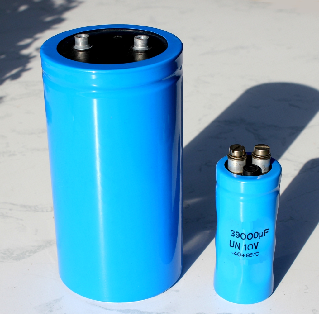 Figure 3 — Large screw-terminal "computer-grade" electrolytics: the biggest bulk-storage cans, bolted rather than soldered, for the high-current reservoir duty in power supplies and amplifiers. Sou…