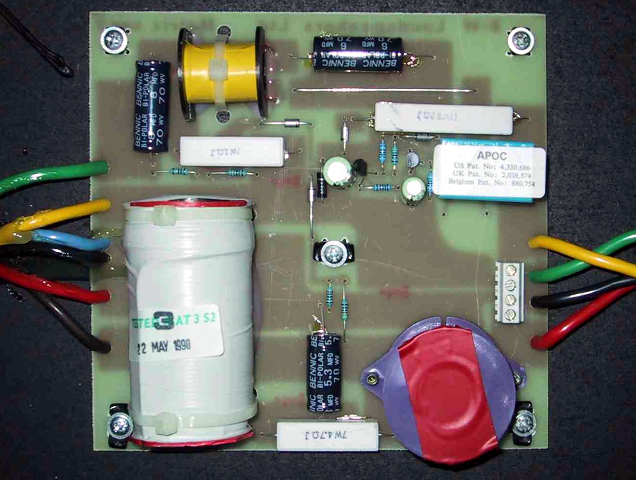 Figure 8 — A loudspeaker crossover network. The large cylindrical components are air-core inductors: many turns of heavy copper on no core at all, chosen so they cannot saturate and add no distorti…