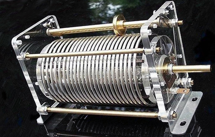 Figure 6 — A roller inductor: a conductive wheel rides against the bare turns of an air-cored solenoid and rolls along the coil as the shaft turns, tapping off a continuously variable number of tur…