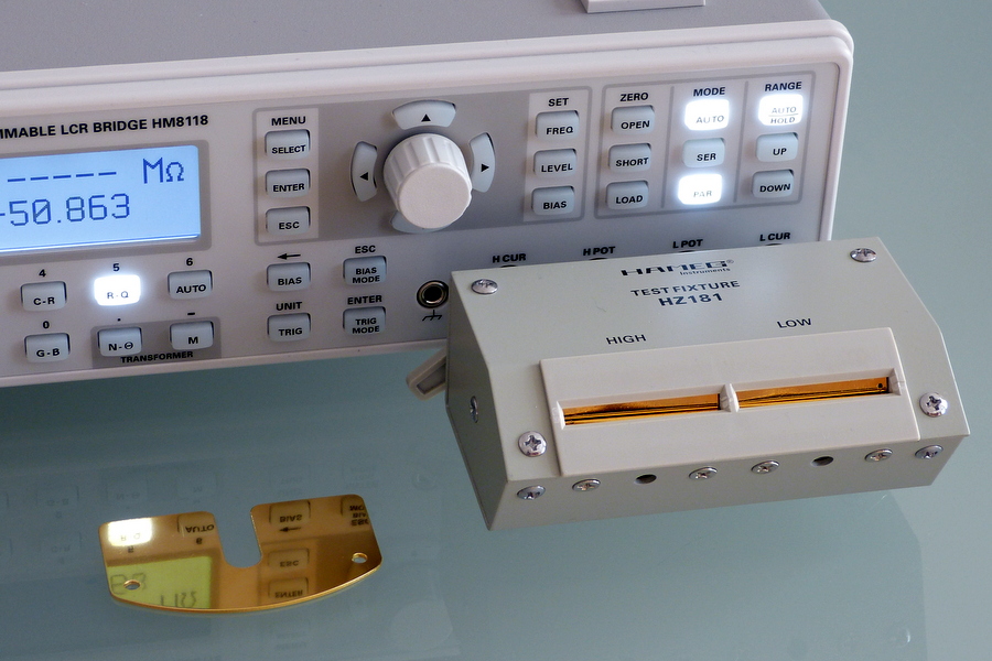 Figure 1 — A benchtop LCR meter with a component fixture. The four terminals (two force, two sense) and the selectable test frequency and level are what separate it from a multimeter — it drives th…