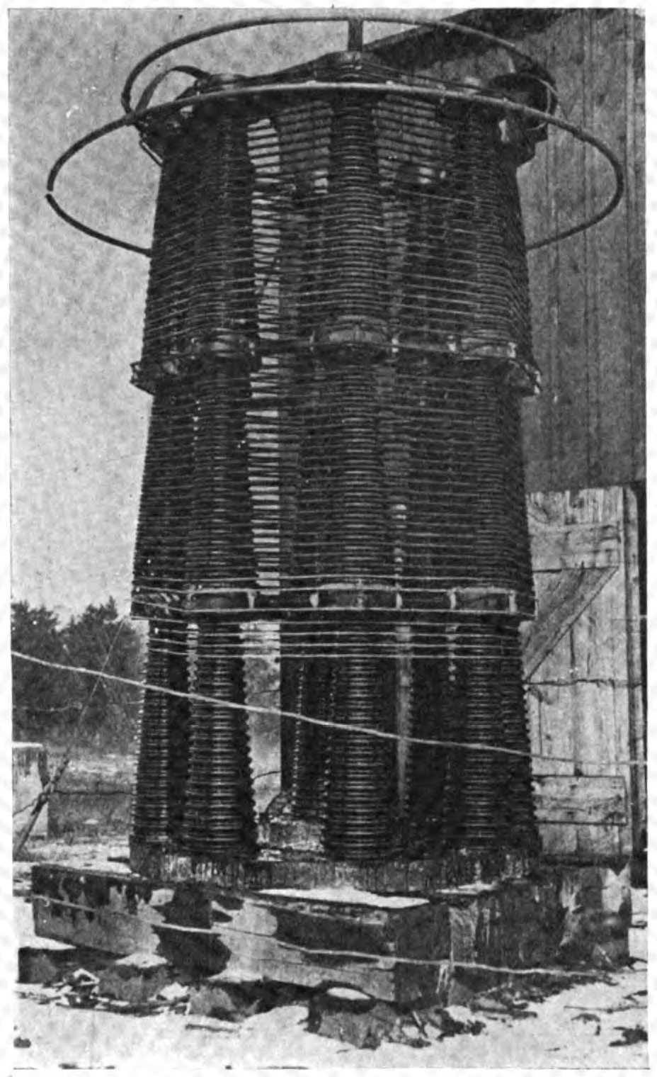 Figure 9 — A large air-cored antenna loading coil at the RCA transatlantic wireless station, New Brunswick, New Jersey, c. 1920. Loading coils add inductance where a line or antenna lacks it; here …