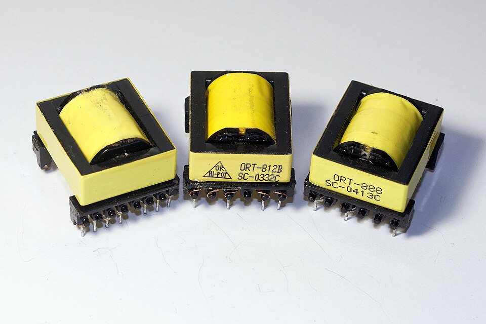 Figure 3 — Ferrite E-cores from switch-mode power supplies. The two-piece E shape accepts a pre-wound bobbin and is easily gapped at the centre leg. Source: Wikimedia Commons (User:Retired electric…