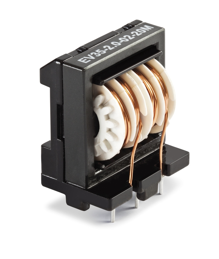 Figure 11 — A commercial common-mode choke: two windings on a shared ferrite core. Source: "Common mode choke 2A with 20mH inductance.jpg" by Holger Urban, Wikimedia Commons, CC BY-SA 4.0.