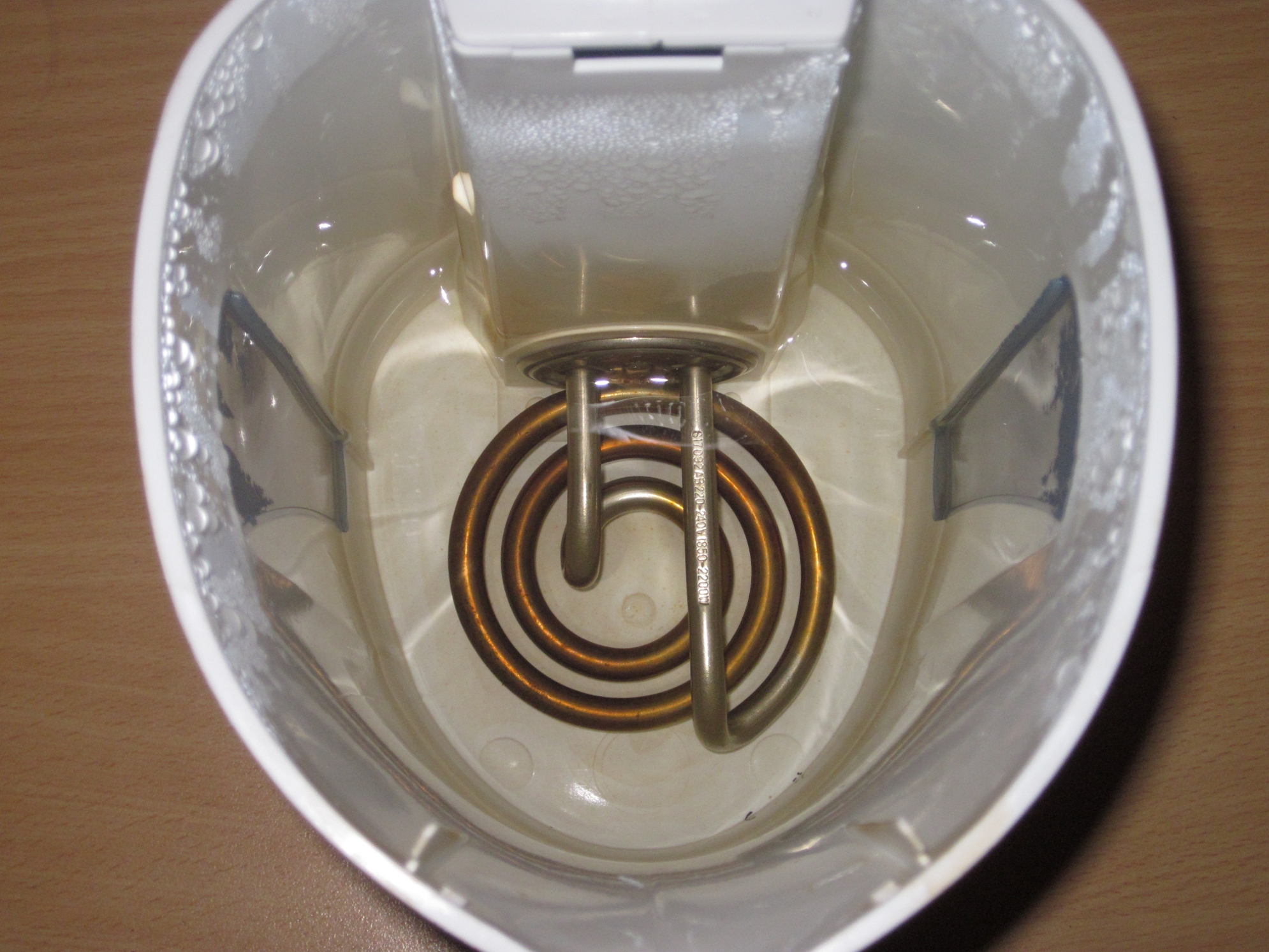 Figure 8 — A resistance-wire heating element in an electric kettle: a real material's resistivity, shaped into a coil, converting electrical power straight to heat (P = I²R). Source: Wikimedia Comm…