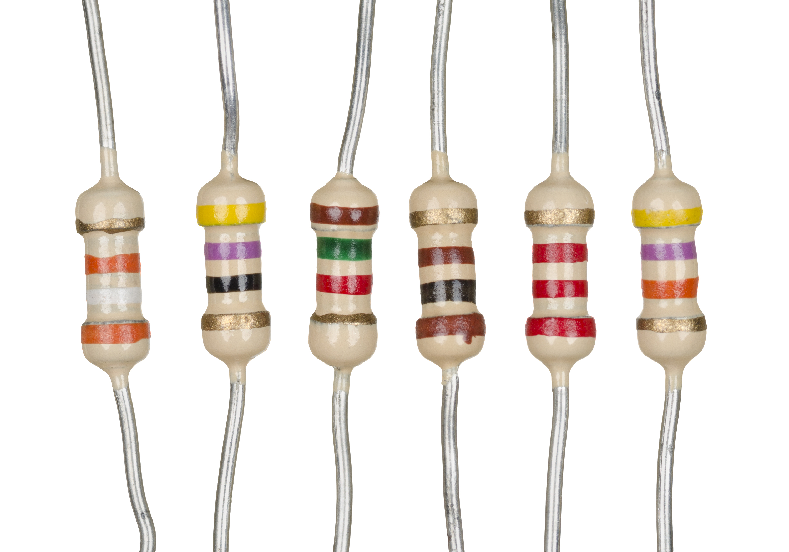 Figure 5 — Modern axial-lead film resistors, the direct descendants of the postwar film revolution. A thin resistive film — carbon or a nickel-chromium alloy — is deposited on a ceramic rod and hel…