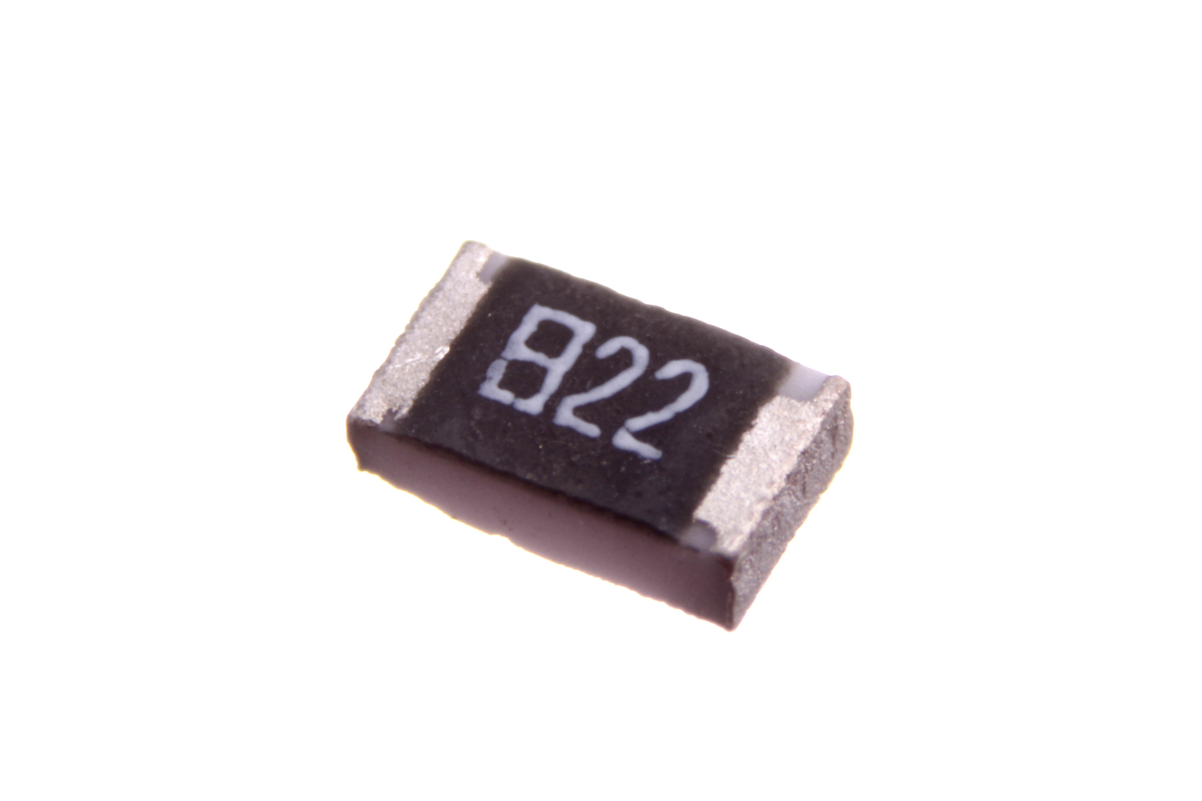 Figure 7 — A modern surface-mount chip resistor (an 0805 case, about 2 mm long). Thick-film resistive paste is screen-printed on an alumina tile, fired, laser-trimmed to value, and given metallised…