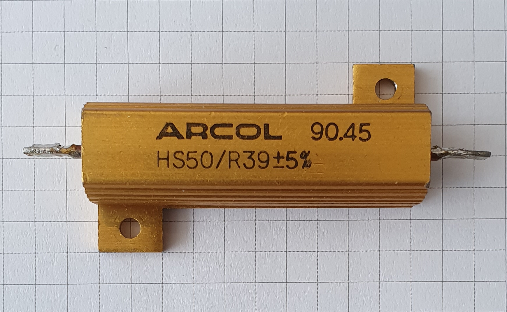 Figure 1 — An aluminium-clad (aluminium-housed) power wirewound resistor: an Arcol HS50, 0.39 Ω ±5%, rated 50 W. The resistance wire and its ceramic core are potted inside a finned, anodized alumin…