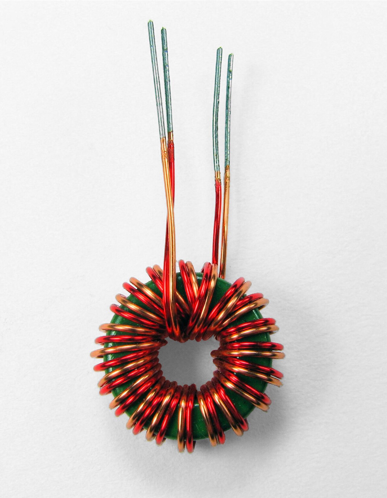 Figure 7 — A toroidal transformer wound bifilar directly onto the ring core, with no bobbin. On a toroid the insulation system is the wire enamel plus hand-wound tape barriers and the core's own co…